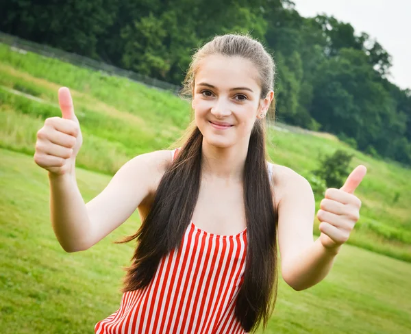 Woman holding thumbs up for success — Stock Photo, Image