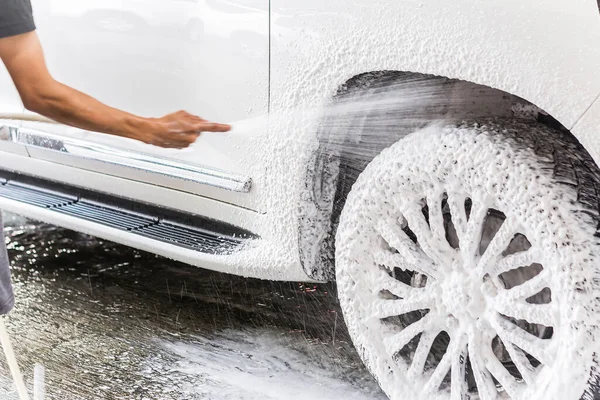 A Man Uses a Hand Pump Car Foam Sprayer on the Rims and Tires of a White  Sedan. Stock Photo - Image of manual, customized: 239604054