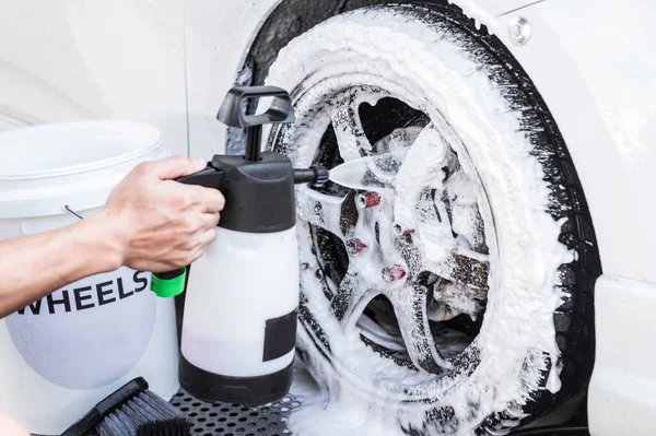 A Man Uses a Hand Pump Car Foam Sprayer on the Rims and Tires of a White  Sedan. Stock Photo - Image of manual, customized: 239604054