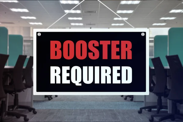 Booster shot required Sign at an office place. Vaccination requirement for employment at work.