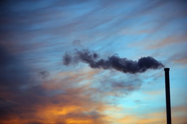Smoking factory chimney at sunset, The Netherlands — Stock Photo, Image