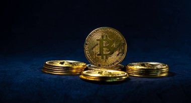 Golden Bitcoin, Bitcoin in the middle of circle of stack on dark blue background. Copy space.