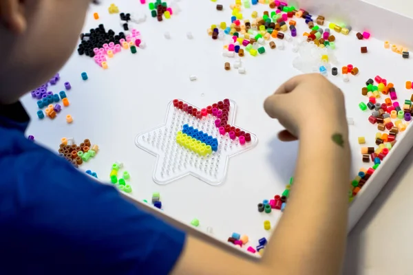 Child Plays Thermo Mosaic Boy Playing White Table — Stock Photo, Image