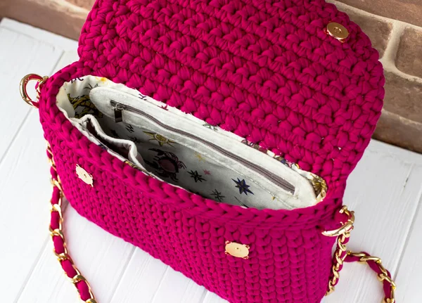 Knitted bag made of knitted yarn. Lining with pockets. Bag view inside