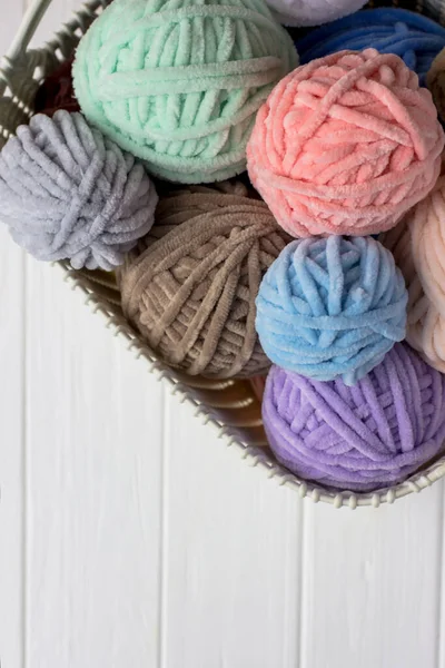 Tangles of plush yarn. Basket with knitting threads. Plush yarn