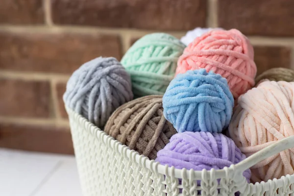 Tangles of plush yarn. Basket with knitting threads. Plush yarn