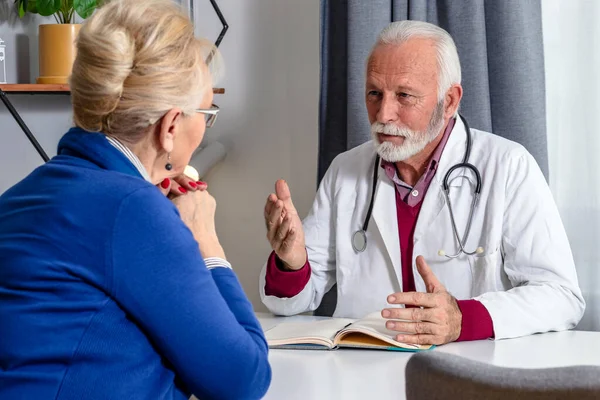 Médico Experiente Discutindo Com Paciente Sexo Feminino Sênior Seu Arquivo — Fotografia de Stock