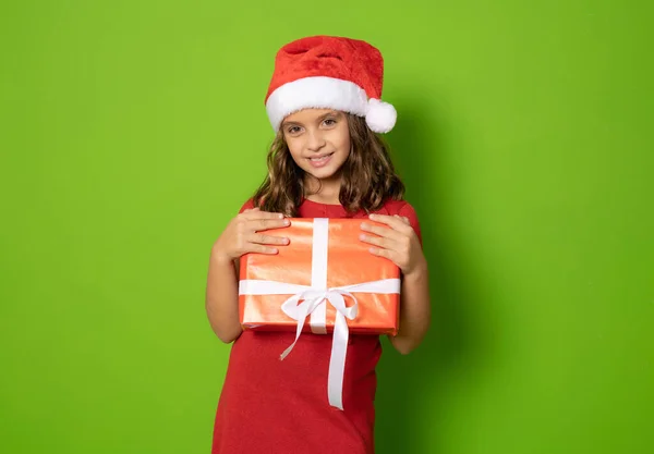 Lächelndes Junges Mädchen Rotem Kleid Und Weihnachtsmannmütze Mit Geschenkverpackung Und — Stockfoto