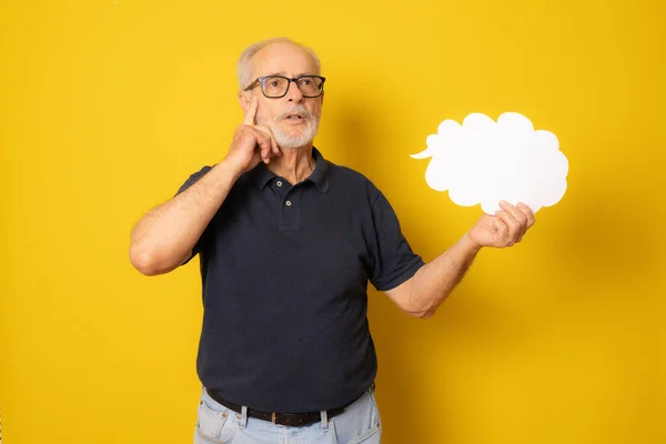 Pensive Senior Man Holding Paper Cloud Isolated Yellow Background — Stock fotografie