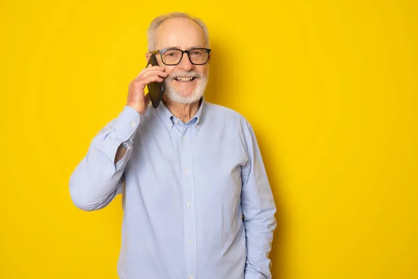 Portrait Happy European Senior Man Talking Phone Smiling Isolated Yellow — Stock Photo, Image