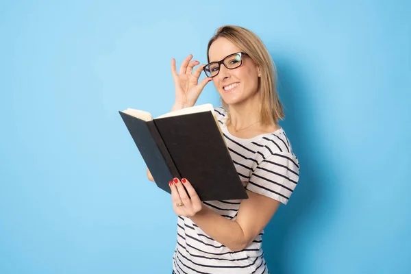 Beautiful Smiling Woman Reading Book Isolated Blue Background — Stock Fotó