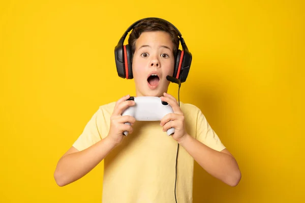 Boy Having Fun Playing Video Console Isolated Yellow Background — Stockfoto
