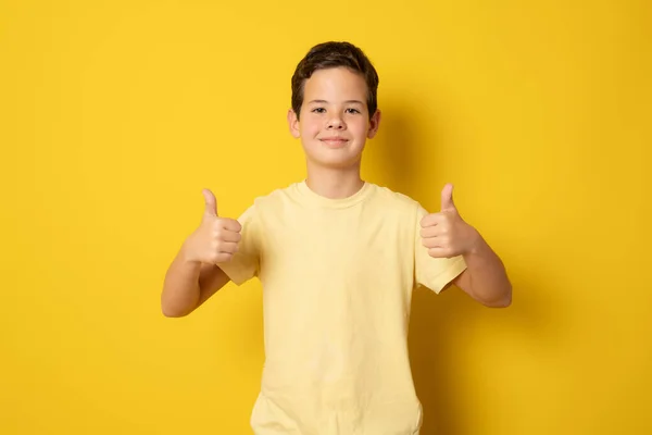 Smiling Boy Casual Shirt Showing Thumbs Standing Isolated Yellow Background — Stockfoto