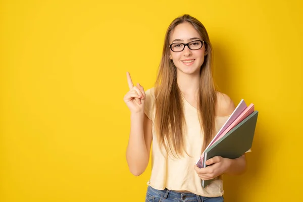 Portrait Cute Young Student Girl Holding Colorful Notebooks Pointing Finger — Stock Photo, Image