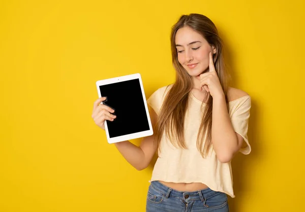 Young Pensive Girl Wearing Casual Clothing Holding Tablet Computer Isolated — Stock Photo, Image