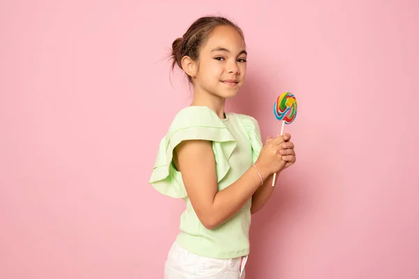 Beautiful Cute Little Girl Eating Lollipop Standing Isolated Pink Background — Stok fotoğraf