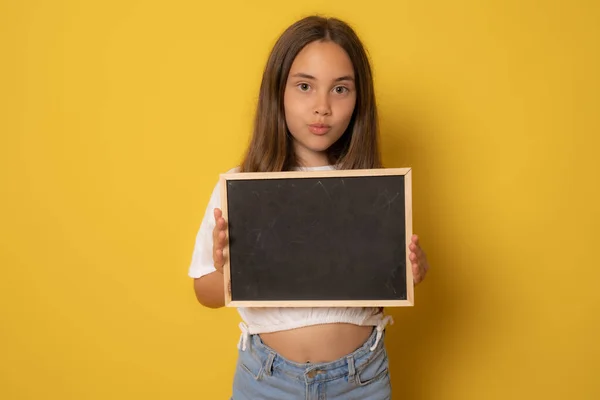 Girl Holding Board Sheet Cute Girl Chalk Board Yellow Background — Stock Photo, Image