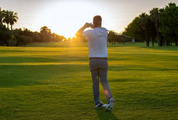 Good Strike Golfer Swinging His Driver Looking Away While Standing — Fotografia de Stock