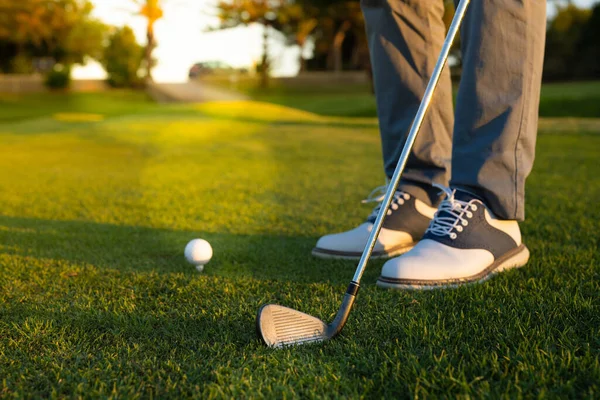 Close up of Golf ball on green grass ready to be struck.