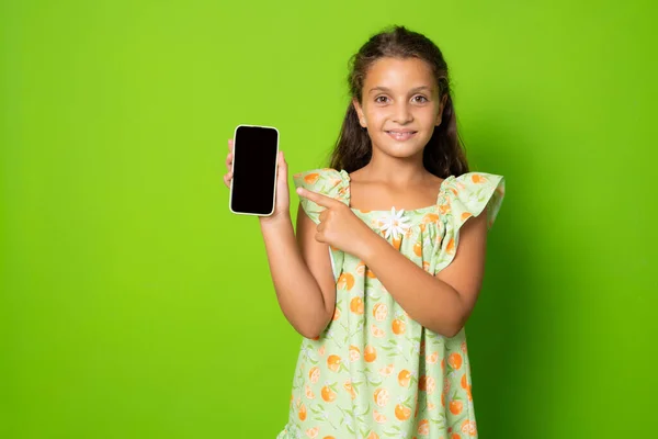 Little Girl Showing Smart Phone Screen Standing Isolated Green Background —  Fotos de Stock