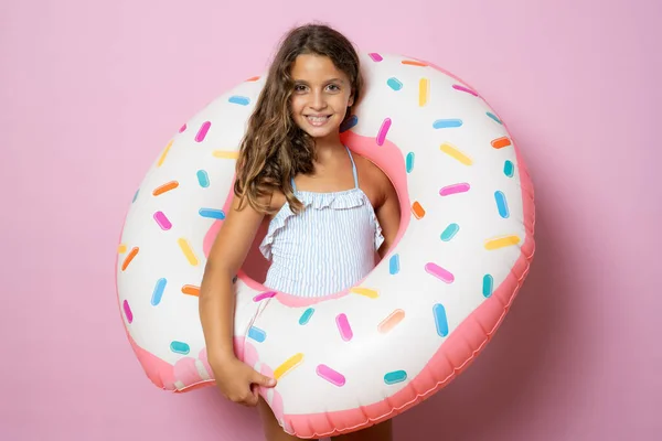 Little Brunette Cute Girl Holding Big Rubber Ring Pink Background — Stockfoto