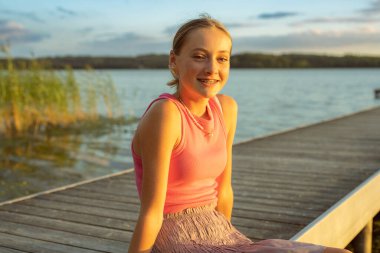 Portrait of a happy smiling teen girl with dental braces in a park.