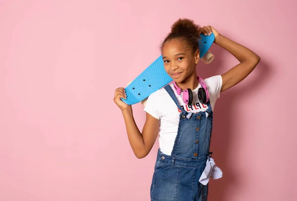 Happy Preteen Girl Holding Skateboard Her Shoulder Isolated Pink Background — Stock Photo, Image