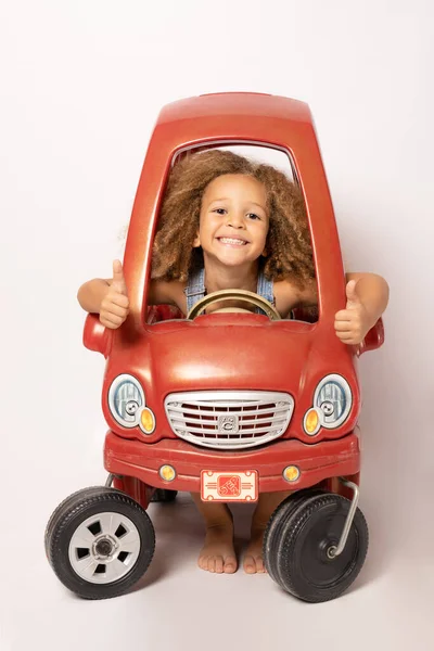 Cute Little Child Girl Driving Children Electric Toy Car Thumbs — Stock Photo, Image