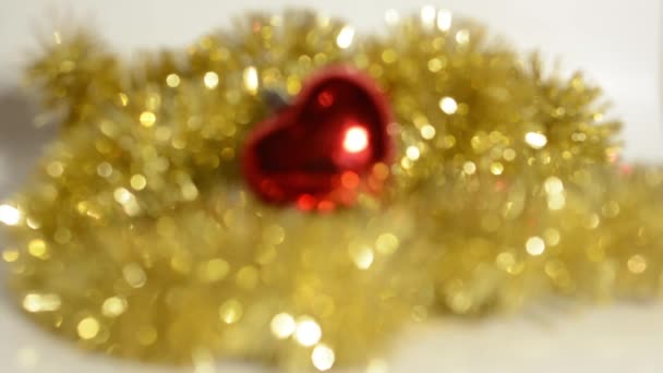 Christmas Decoration - red ornament with gold chain - blurred shot — Stock Video