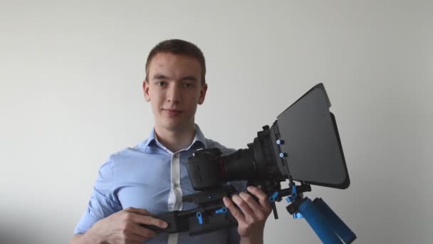 Uomo con macchina fotografica professionale (rig) e sorrisi — Video Stock