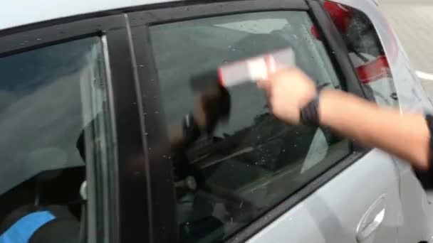 Hombre lavando ventana de coche con limpiador de ventanas — Vídeos de Stock