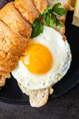 Kızarmış yumurta kruvasanı, sebze salatası domates, salatalık hazır yemek atıştırmalığı fotokopi masasında uzay yemeği arka plan kırsal keto veya paleo diyet vejetaryen yemeği 