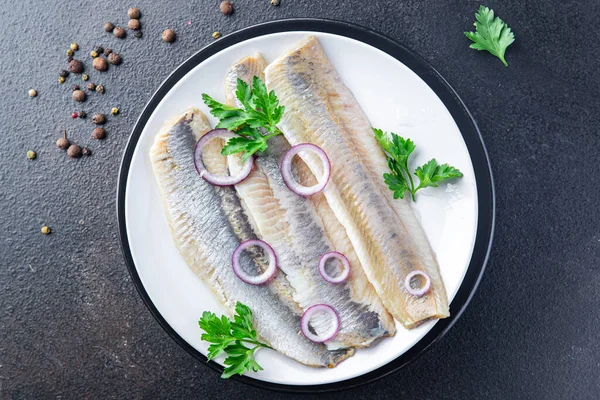 herring fish fillet seafood a portion ready to eat meal snack on the table copy space food background rustic. top view pescetarian diet