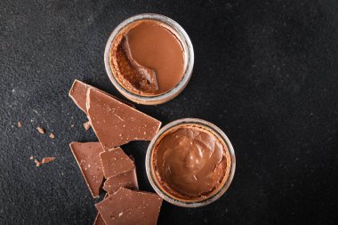 chocolate dessert cream avocado and cocoa powder no dairy, no lactose healthy meal food snack on the table copy space food background rustic top view