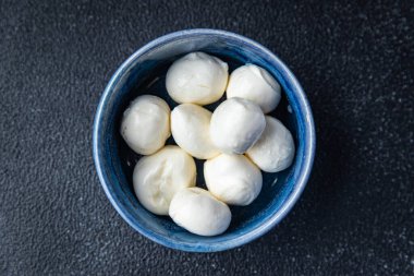 mozzarella small balls cow's milk or buffalo, goat healthy meal food snack on the table copy space food background rustic top view