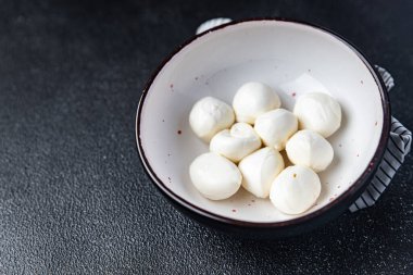 mozzarella small balls cow's milk or buffalo, goat healthy meal food snack on the table copy space food background rustic top view