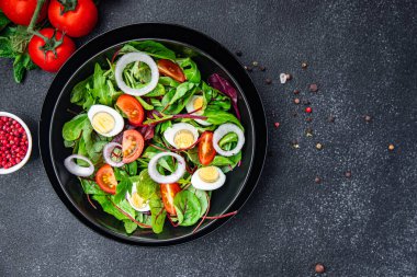 salad quail egg tomato, lettuce mix leaves healthy meal food snack on the table copy space food background rustic top view keto or paleo diet veggie vegetarian food no meat