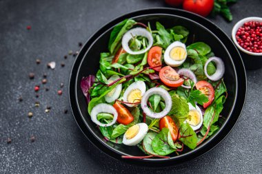 Paskalya salatası bıldırcın yumurtası bayram atıştırmalığı domates, marul karışımı masada sağlıklı yemek artıkları fotokopi uzayı arka plan kırsal manzarası 