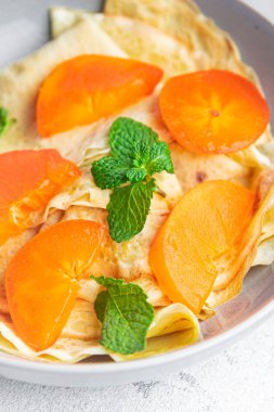 Maslenitsa tatlı kahvaltı kahvaltısı krepleri. Maslenitsa kahvaltı atıştırmalıkları. Masanın arka planında uzay yiyeceklerinin fotokopileri var. 