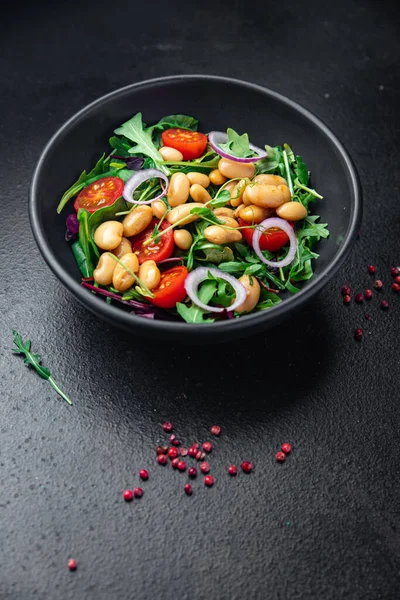 white bean salad , tomato, leaves lettuce mix fresh healthy meal food diet snack on the table copy space food background