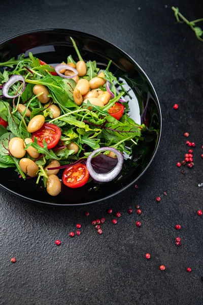 white bean salad , tomato, leaves lettuce mix fresh healthy meal food diet snack on the table copy space food background