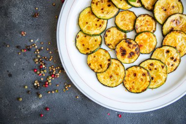 Kabak kızartılmış sebzeler. Fotokopi masasında taze sağlıklı yemek yiyecekler. Arka planda uzay yiyecekleri.