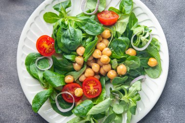 vegetable salad chickpea, legume, lettuce, mache, tomato fresh healthy meal food snack diet on the table copy space food background