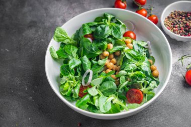 vegetable salad chickpea, legume, lettuce, mache, tomato fresh healthy meal food snack diet on the table copy space food background