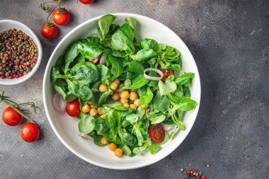 vegetable salad chickpea, legume, lettuce, mache, tomato fresh healthy meal food snack diet on the table copy space food background