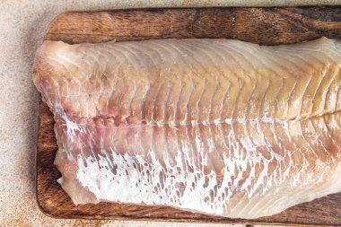 raw saithe fish fillet without bones fresh dish healthy meal food snack diet on the table copy space food background rustic top view pescatarian diet