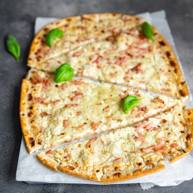 Flammkuchen savory pie bacon, onion, sour cream pastrie meal food snack on the table copy space food background