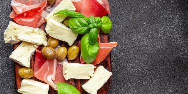 meat platter or cheese platter jamon, cheese, olives healthy meal food snack on the table copy space food background rustic top view