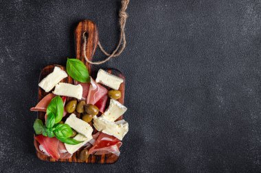 meat platter or cheese platter jamon, cheese, olives healthy meal food snack on the table copy space food background rustic top view