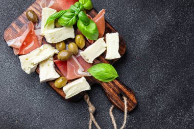 meat platter or cheese platter jamon, cheese, olives healthy meal food snack on the table copy space food background rustic top view